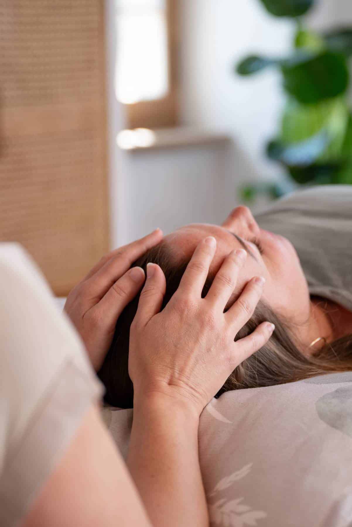 Nathalie Briatore bei einer sanften Craniosacral Therapie Behandlung am Kopf.